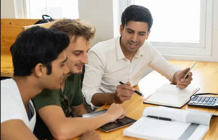 Students attending a financial literacy class in school where a teacher explains budgeting and money management basics.